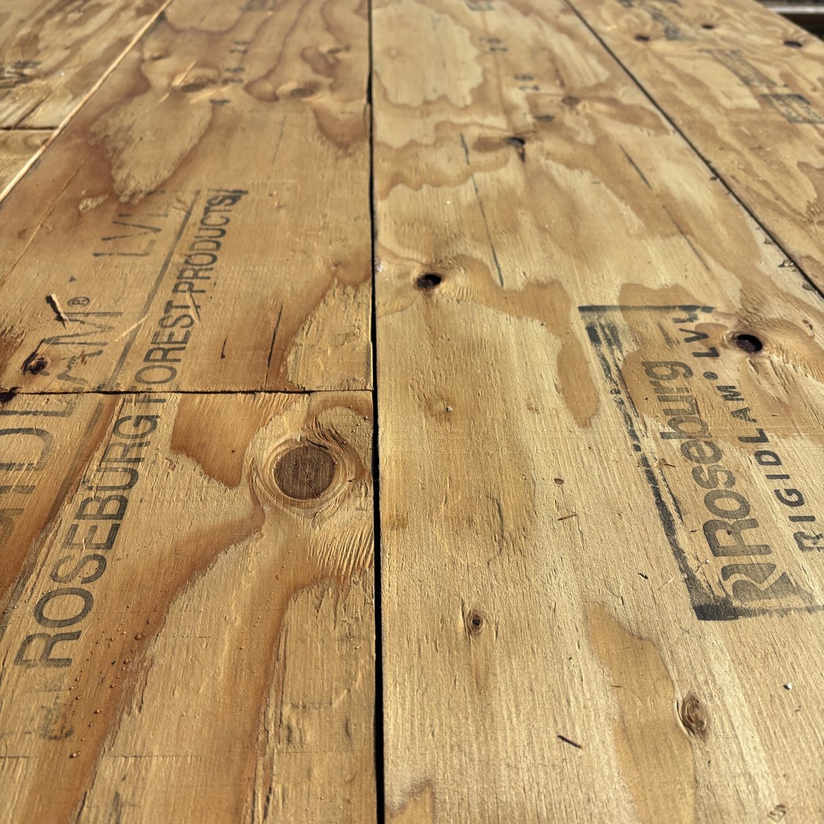 Close-up angled view of wood grain texture on 1 3/4 inch by 11 7/8 inch LVL showing layered veneer structure