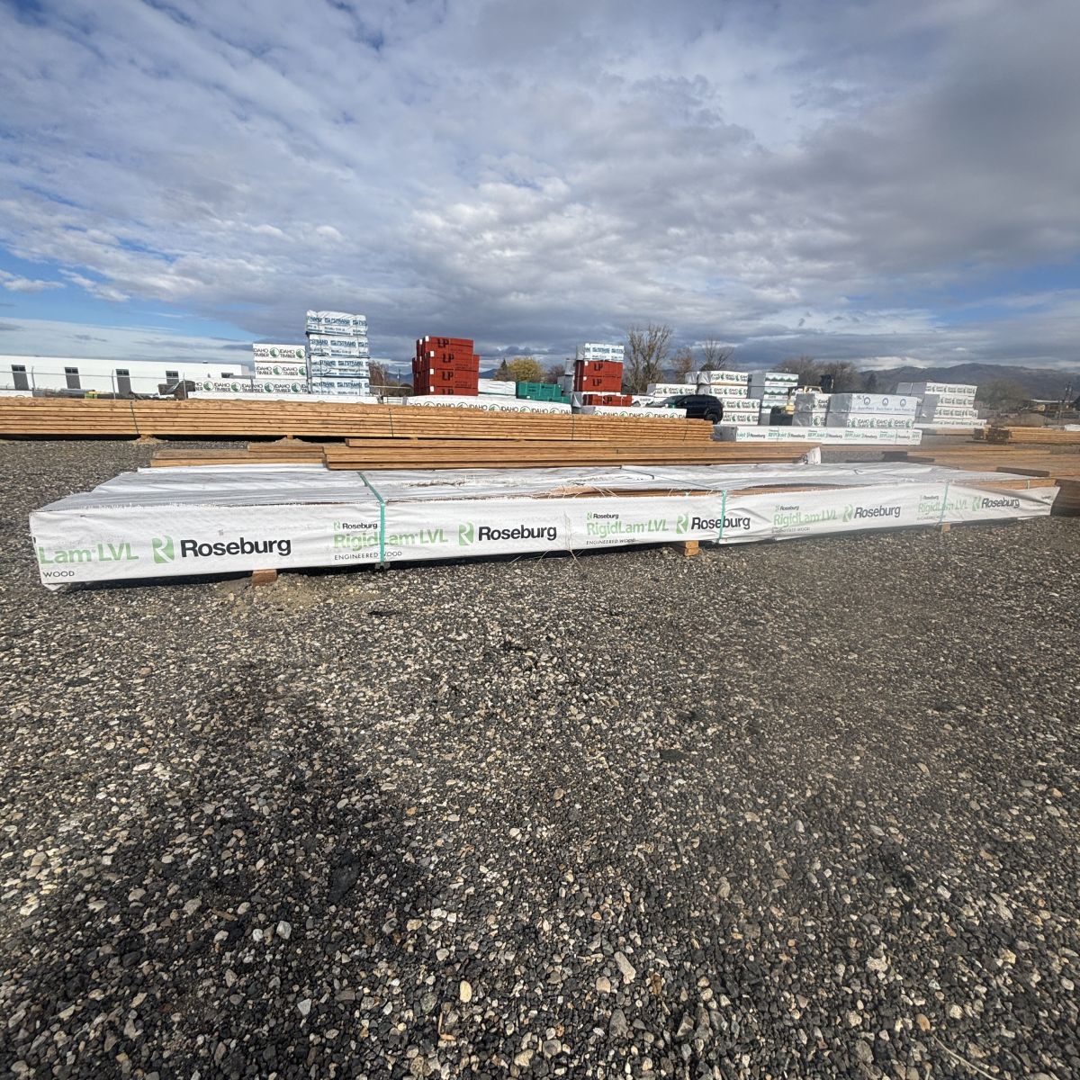 Polywrapped Roseburg RigidLam 1-3/4 inch by 9-1/2 inch laminated veneer lumber (LVL) beam shown at Boise lumberyard with yard inventory in background