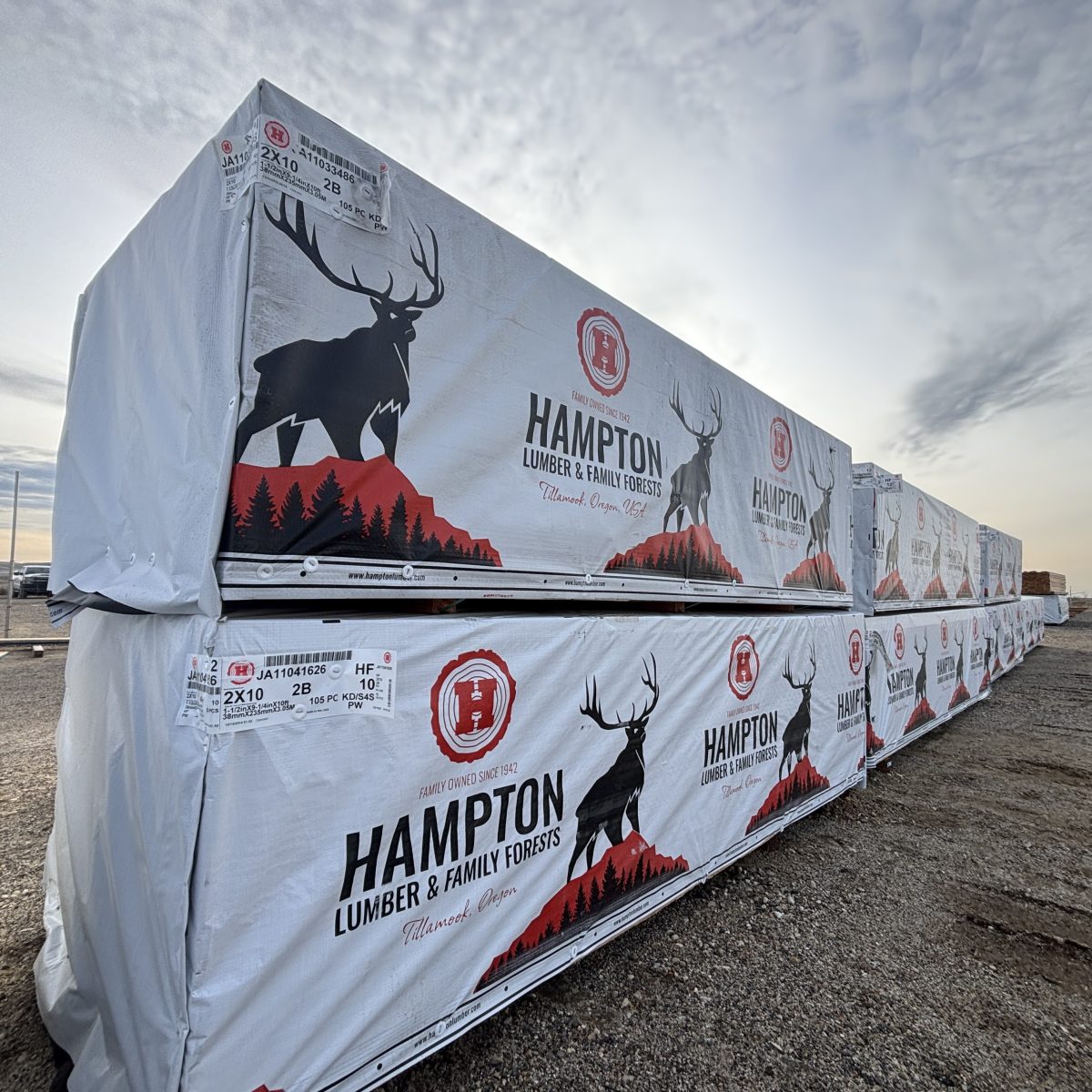 Angled view of 2x10x10 foot number 2 grade kiln-dried Hem-Fir lumber stacked with other lumber SKUs at Boise lumberyard