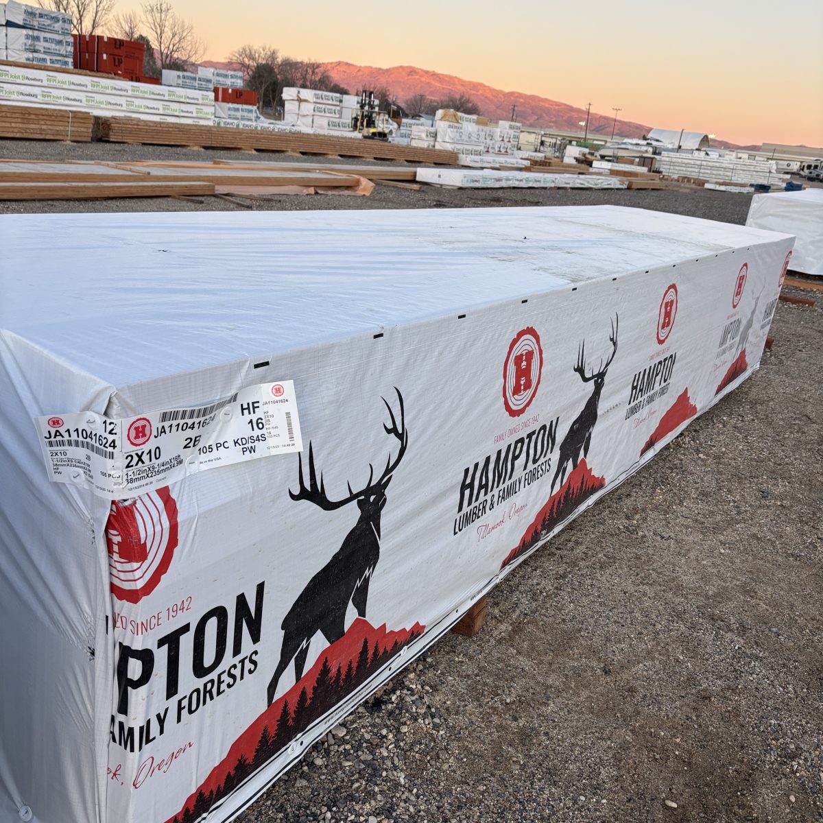 Angled view of 2x10x16 foot number 2 grade kiln-dried Hem-Fir lumber stacked at Boise lumberyard