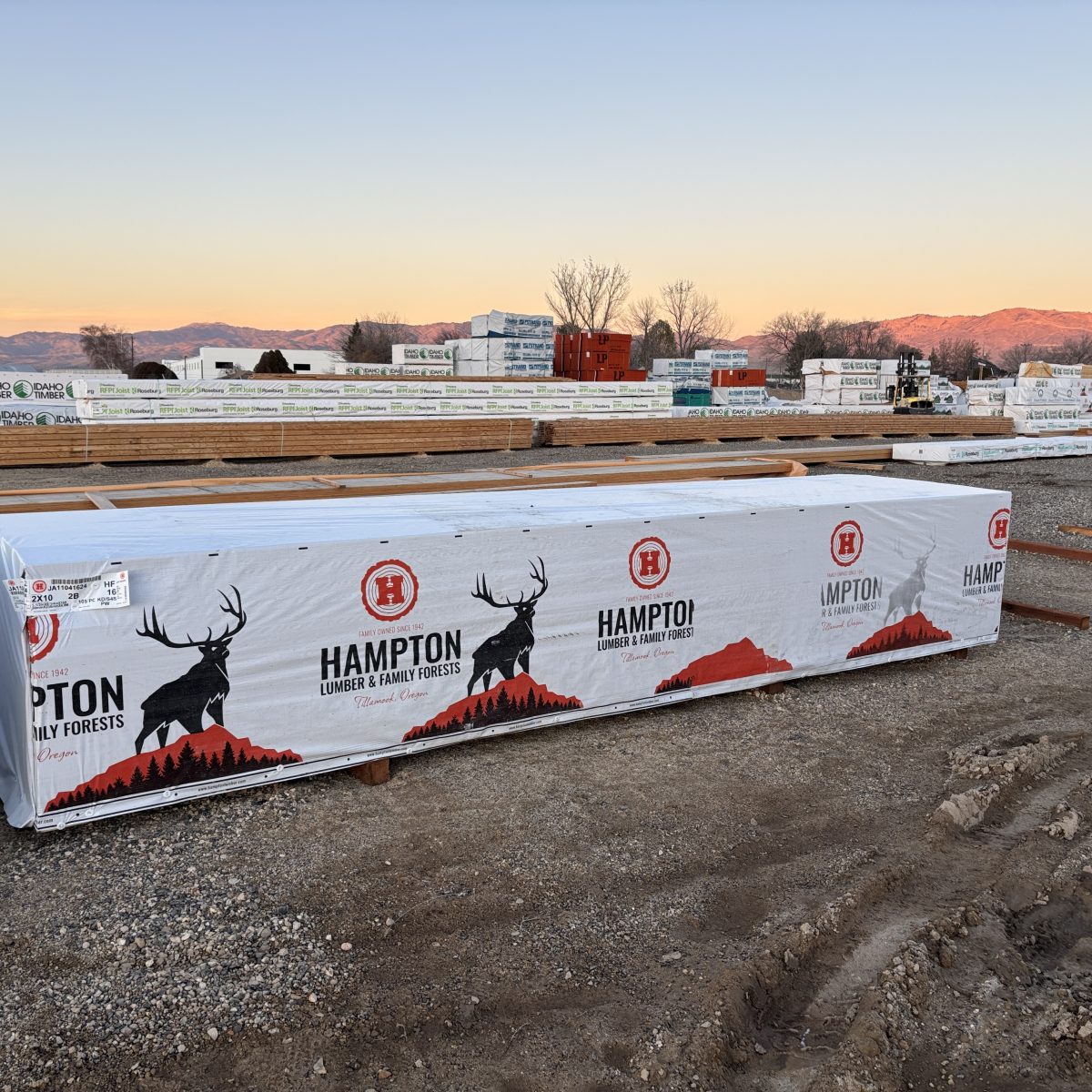 Wide yard view of 2x10x16 foot number 2 grade kiln-dried Hem-Fir lumber stocked at Boise lumberyard