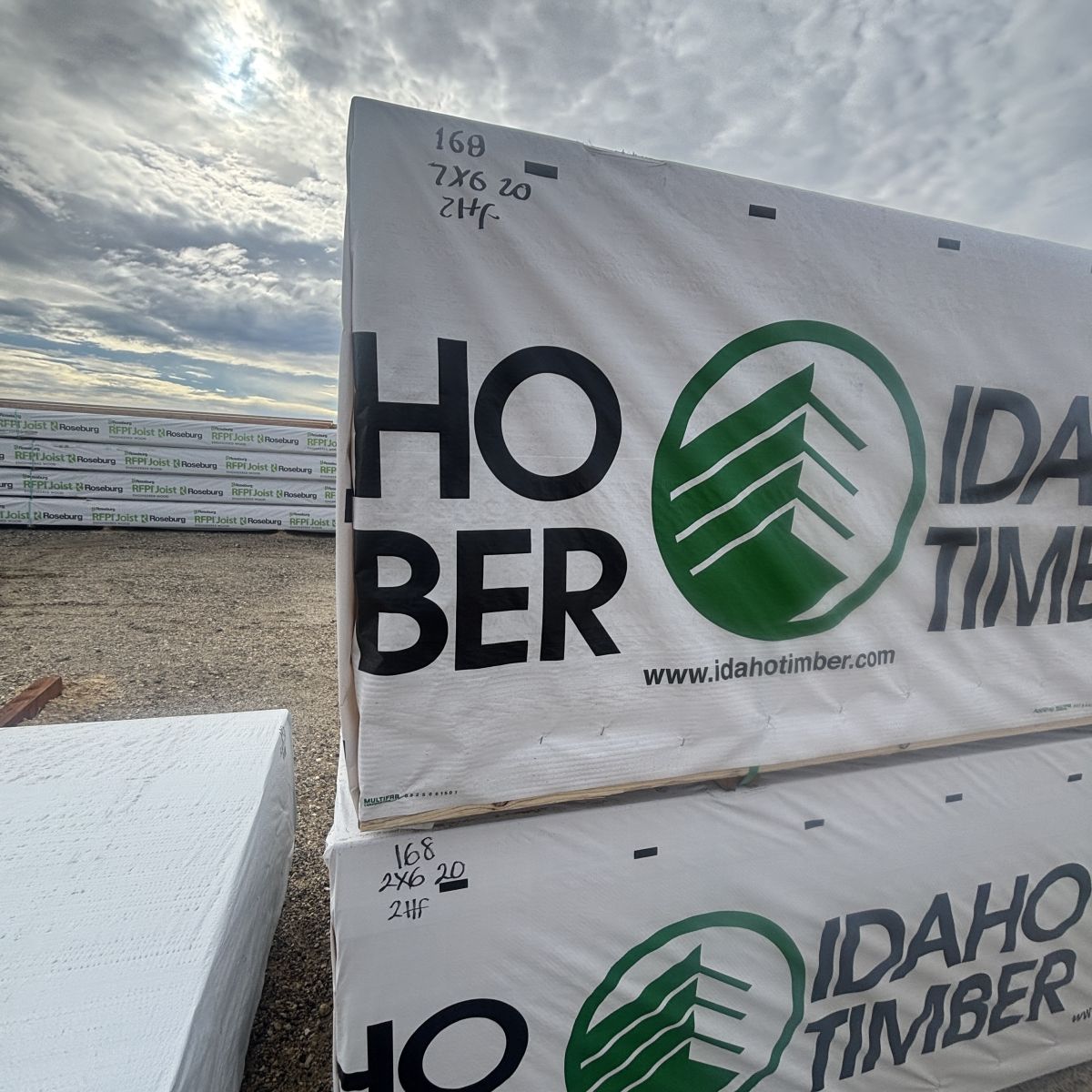 Close-up view of 2×6-20′ #2 kiln-dried Hem-Fir lumber with Boise yard background