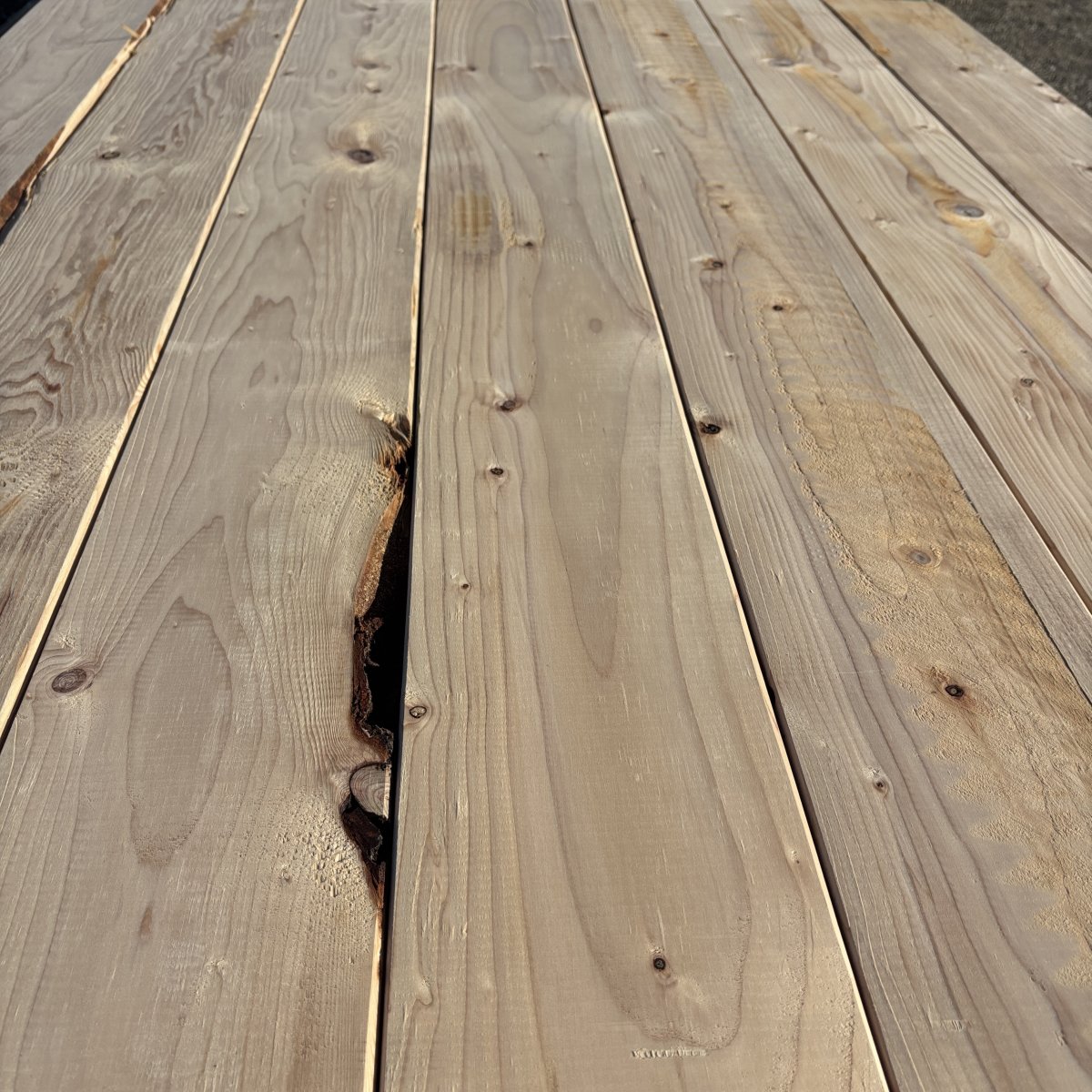 Close-up angled view of Hem-Fir wood grain on 2×8 #2 kiln-dried lumber showing natural texture and grain pattern