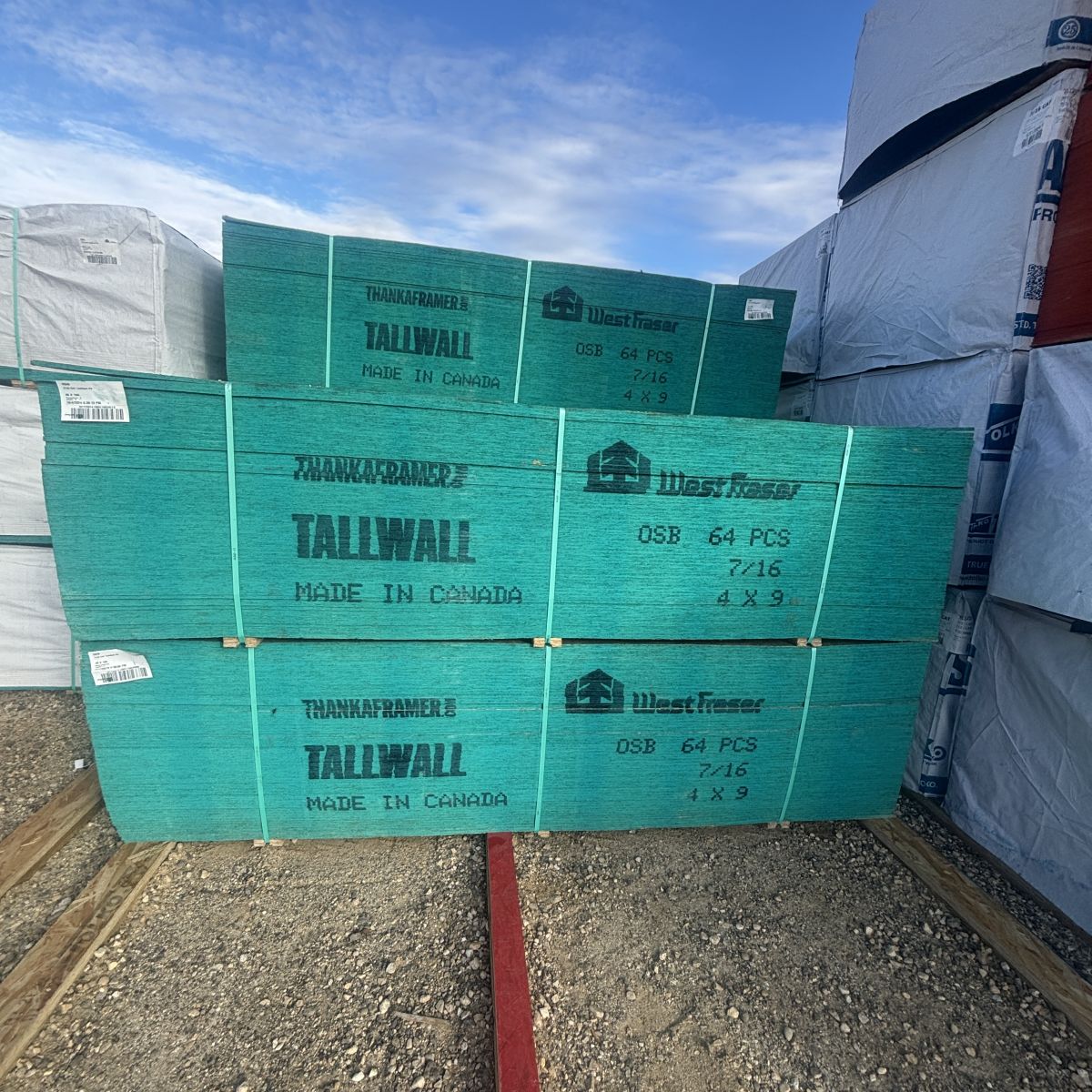 Front view of stacked 7/16-inch 4×9 OSB sheathing on platforms at our Boise lumberyard